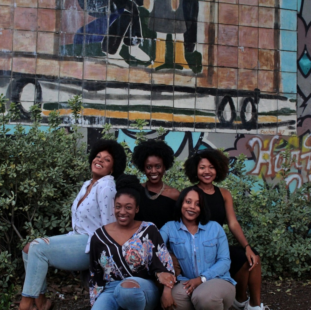 Five women standing together